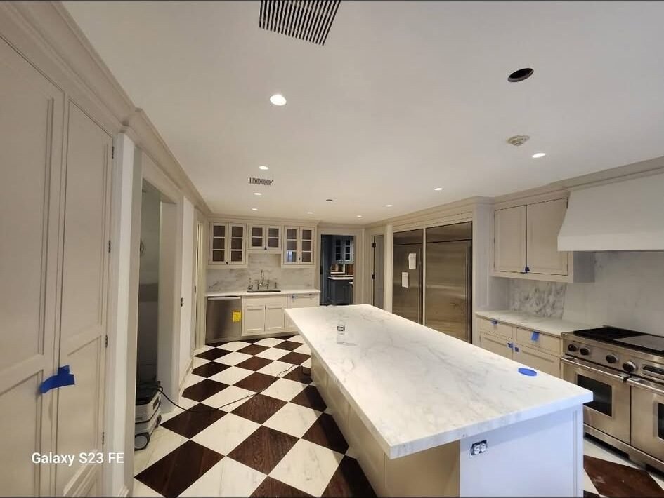 Cream painted kitchen cabinetry with marble island in a Fairfield CT home