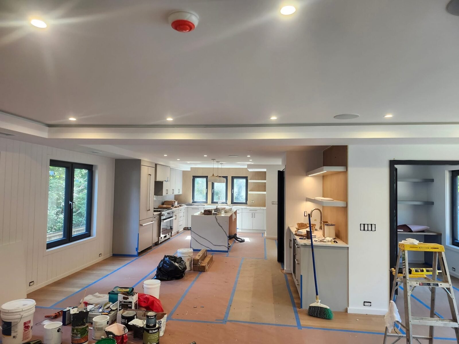 Full floor masking and prep during a large open-plan painting project