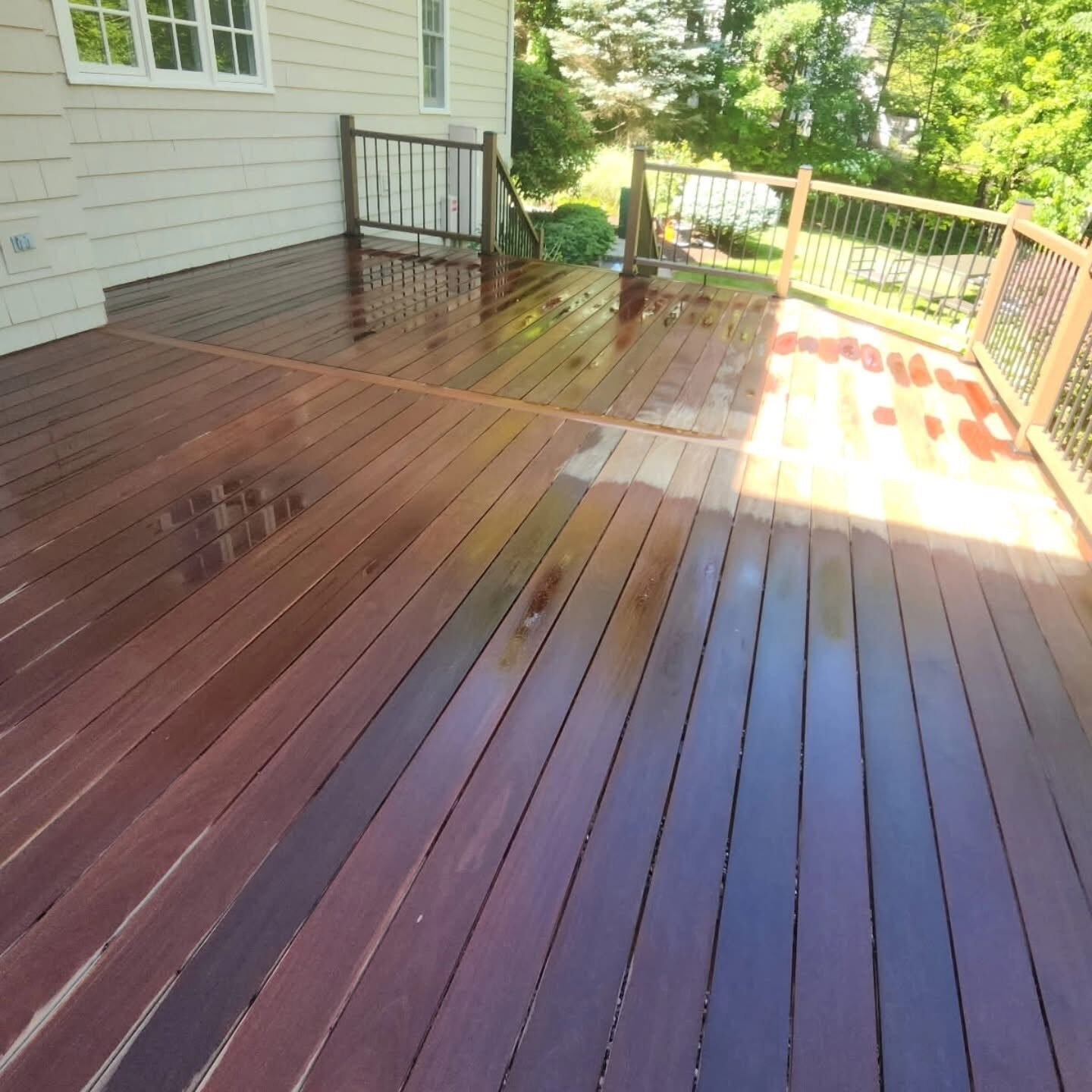 Freshly stained hardwood deck glistening after sealing at a New Canaan CT home
