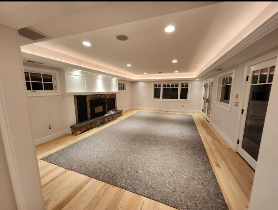 Finished basement family room with freshly painted walls and cove lighting in a Danbury CT home