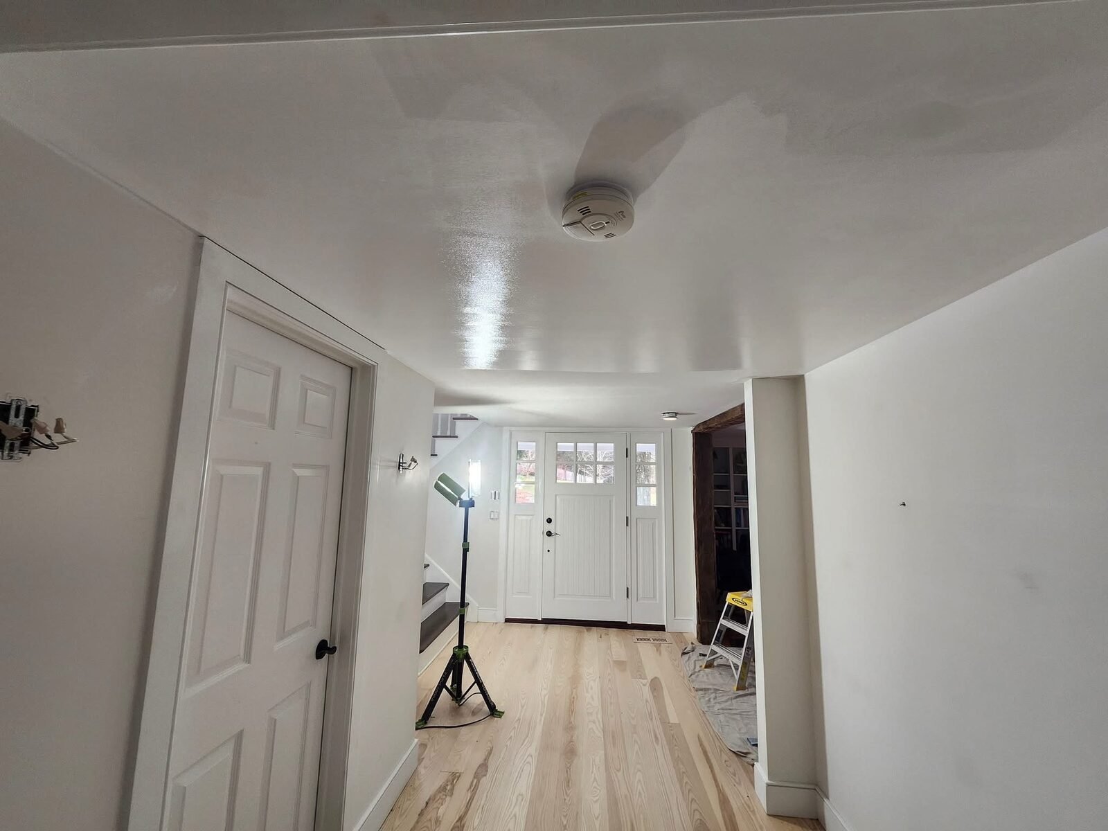 Entry hallway with freshly painted white walls, doors and ceiling in a Fairfield CT home