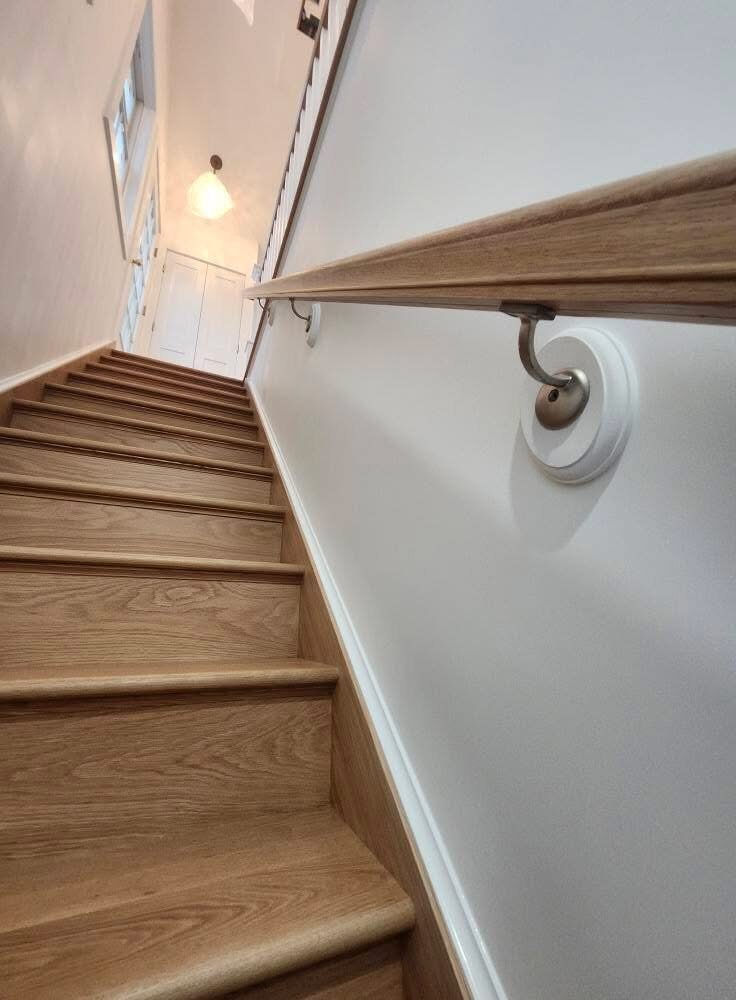 Oak staircase with freshly painted white walls and trim in a Norwalk CT home