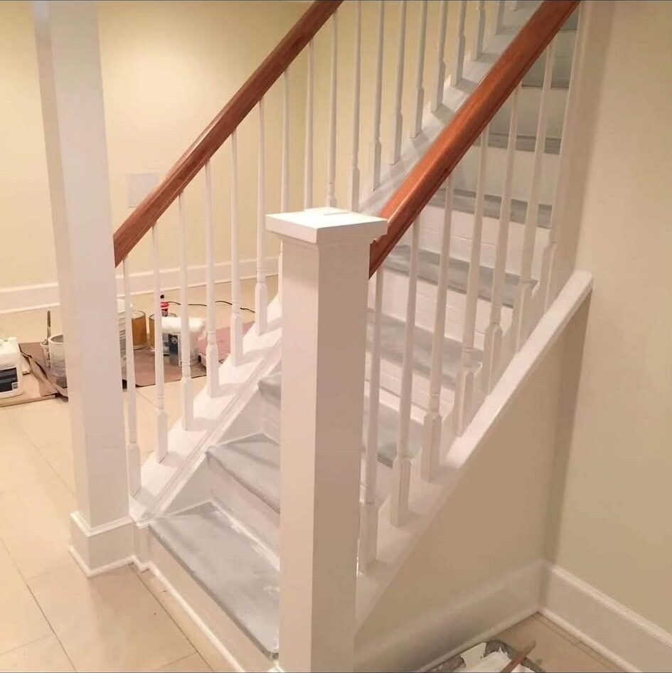 Staircase with white painted balusters and newel post mid-project in a Shelton CT home