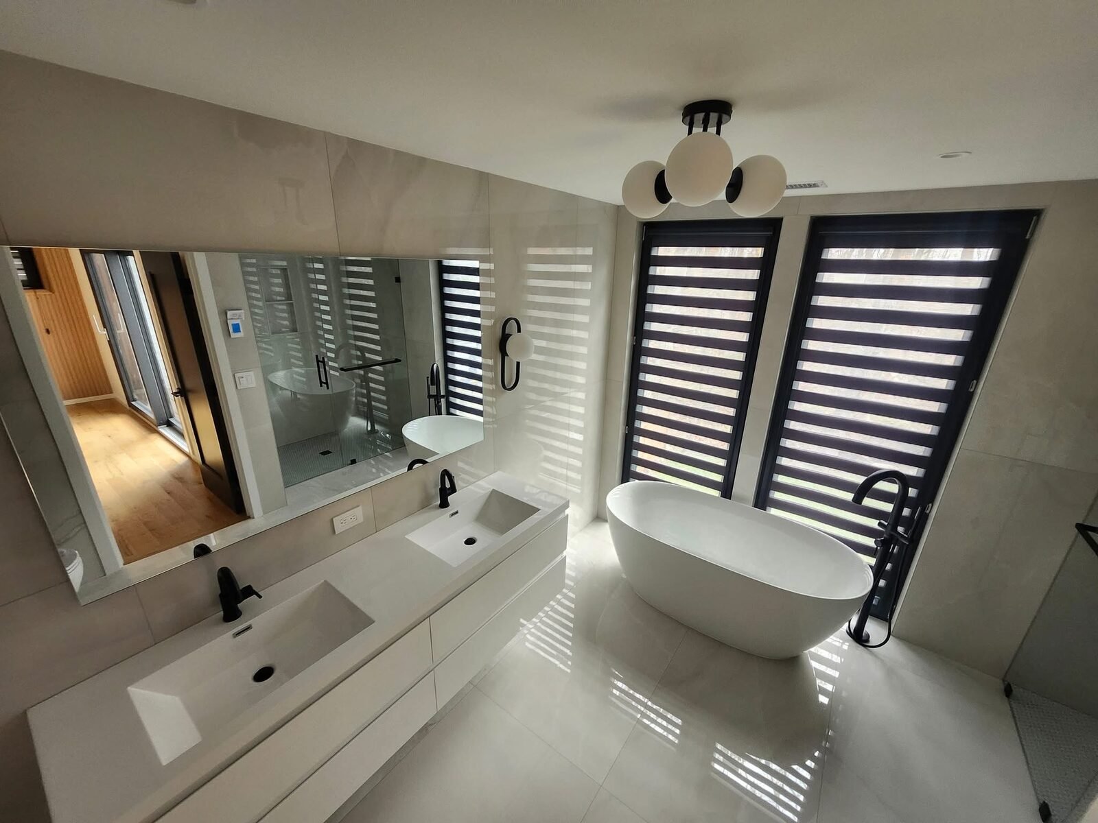 Crisp white walls and ceiling in a modern Westport CT bathroom with freestanding tub