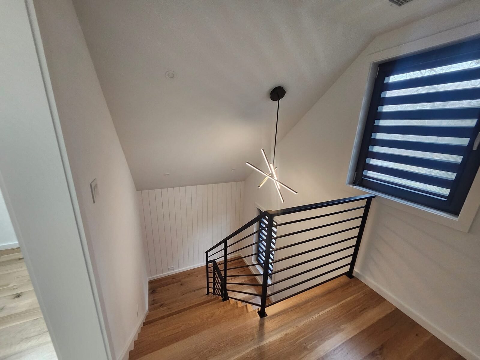 Freshly painted stair landing with shiplap accent wall in a Westport CT home